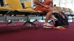 Boy put on flip flops and anklet in airport