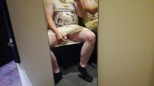 Wearing a summer dress in the changing room